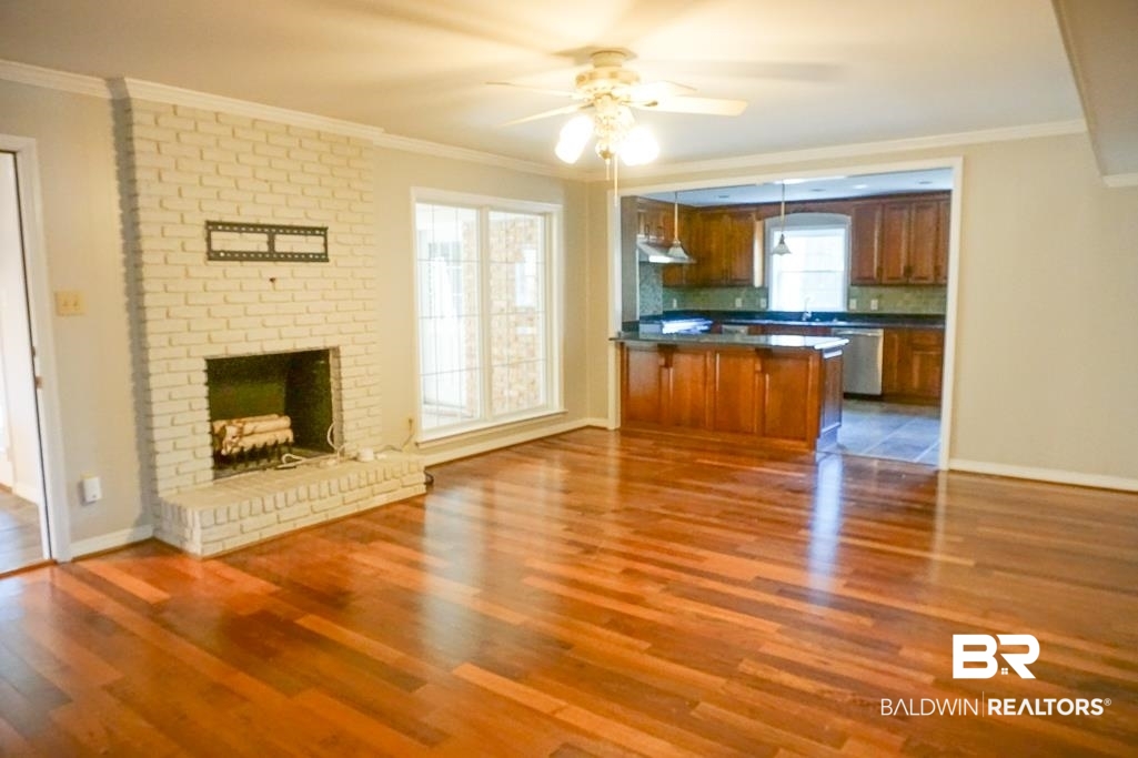 255 Suffolk Road Mobile, AL 36608 - Photo 29 of 29 Kitchen with ornamental molding, open floor plan, wood finish cabinets, dark countertops, and a ceiling fan