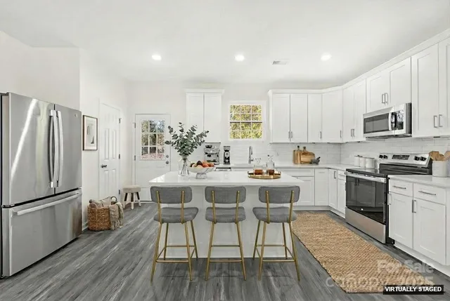 a kitchen with a table and chairs in it