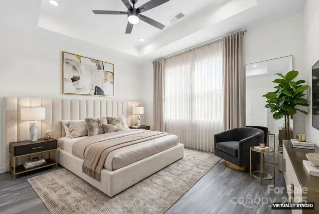 a bedroom with a bed a couch and potted plant