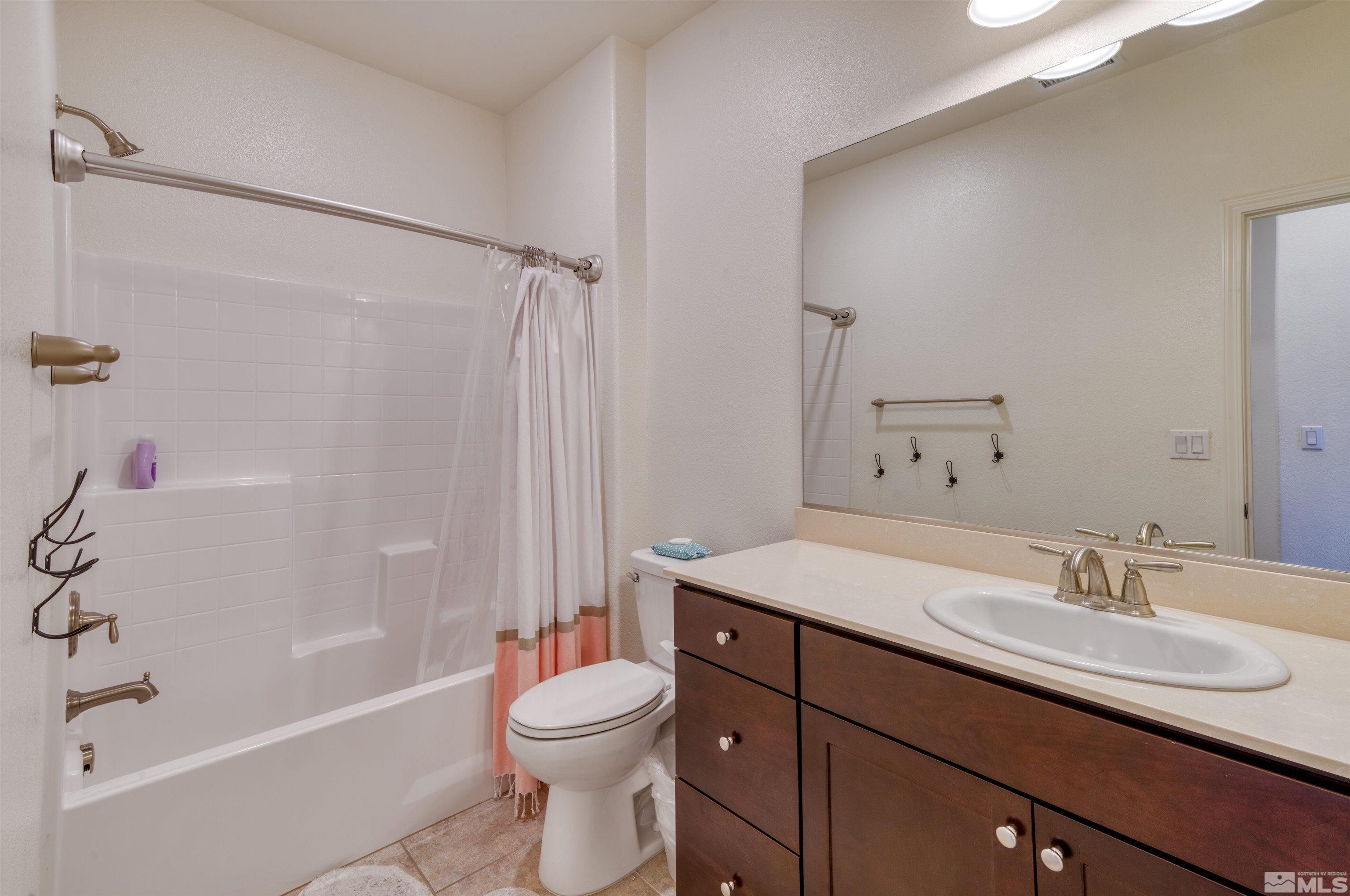 9784 Quartette Drive Reno, NV 89521 - Photo 12 of 18 a bathroom with a sink a toilet and shower