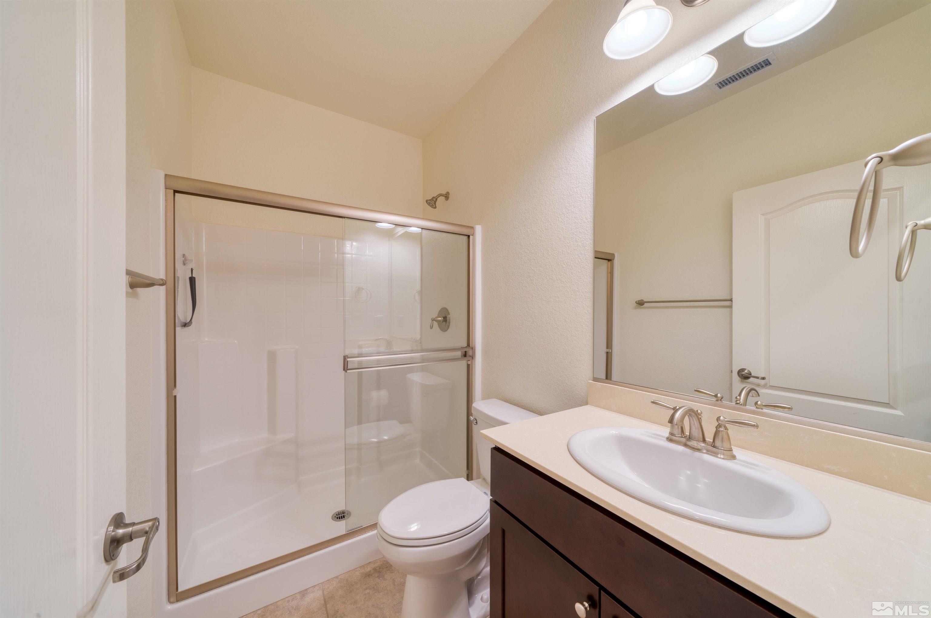 9784 Quartette Drive Reno, NV 89521 - Photo 14 of 18 a bathroom with a sink toilet and shower