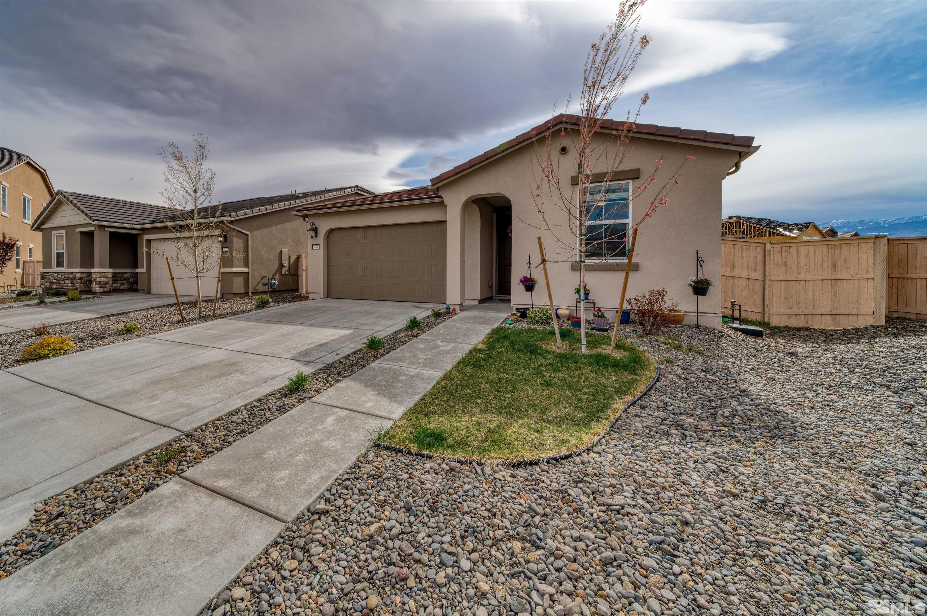 9784 Quartette Drive Reno, NV 89521 - Photo 2 of 18 a front view of a house with garden