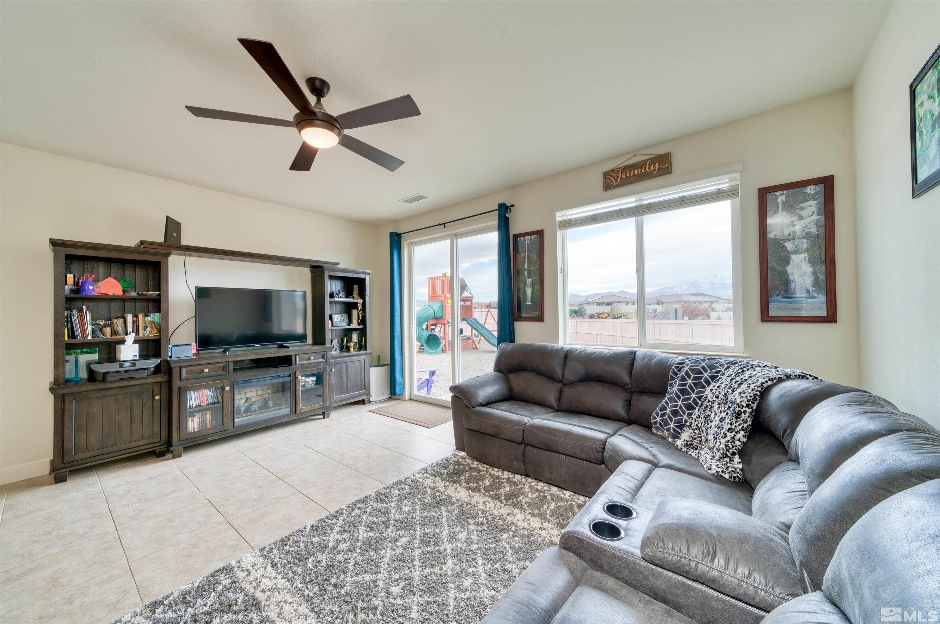 9784 Quartette Drive Reno, NV 89521 - Photo 5 of 18 a living room with furniture and a flat screen tv