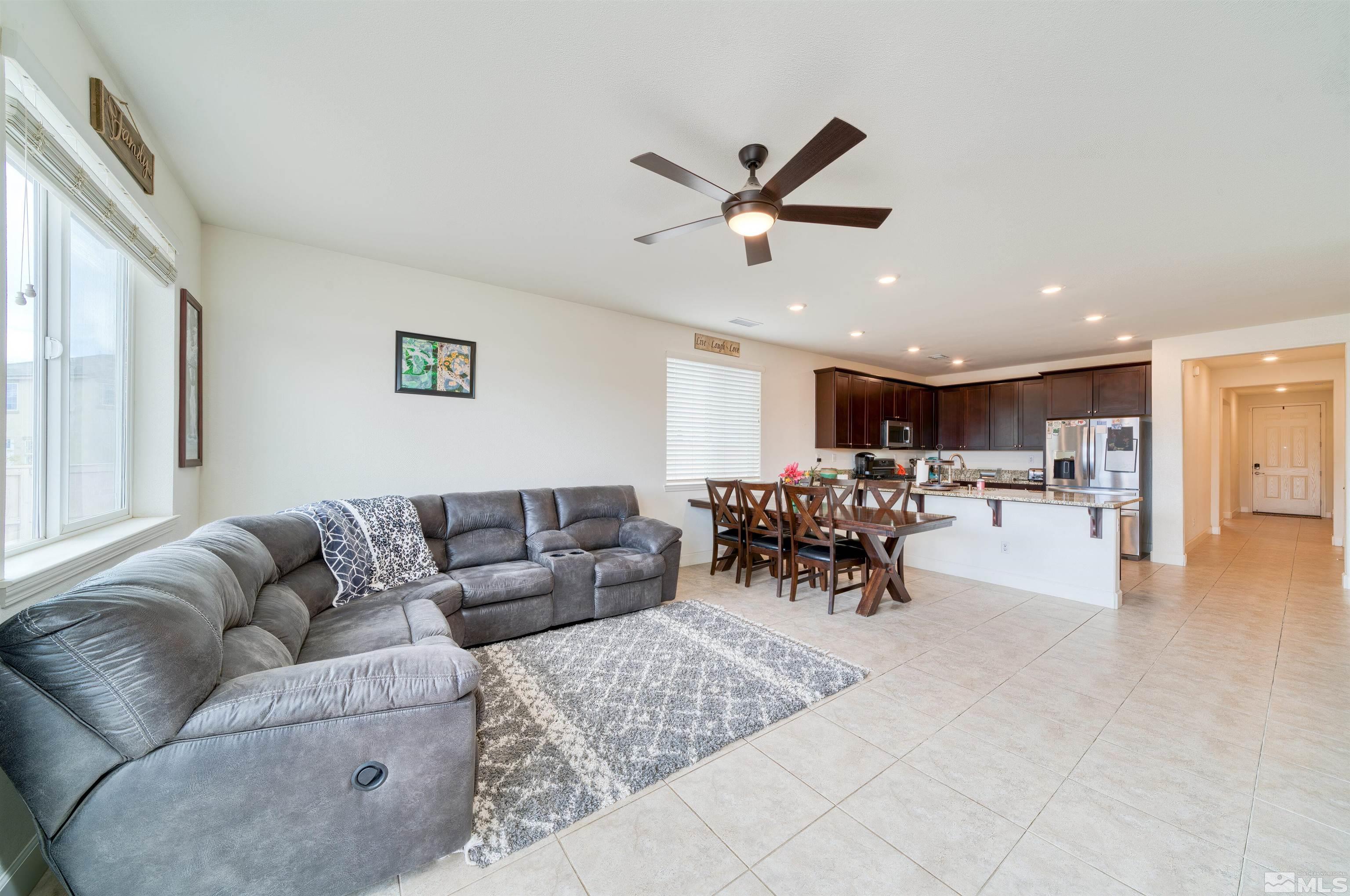9784 Quartette Drive Reno, NV 89521 - Photo 6 of 18 a living room with furniture and a dining table with kitchen view