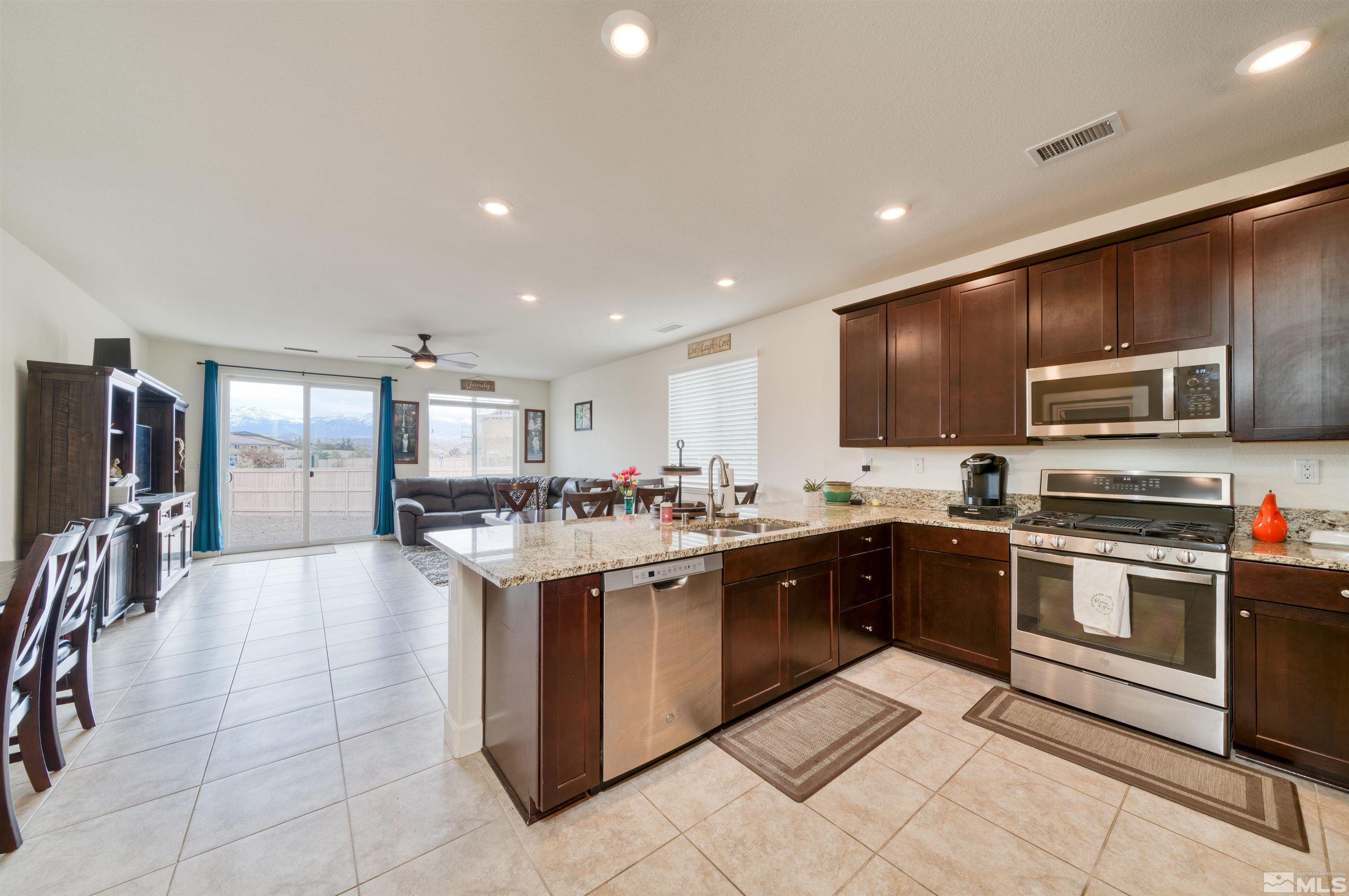 9784 Quartette Drive Reno, NV 89521 - Photo 7 of 18 a large kitchen with stainless steel appliances lots of counter top space