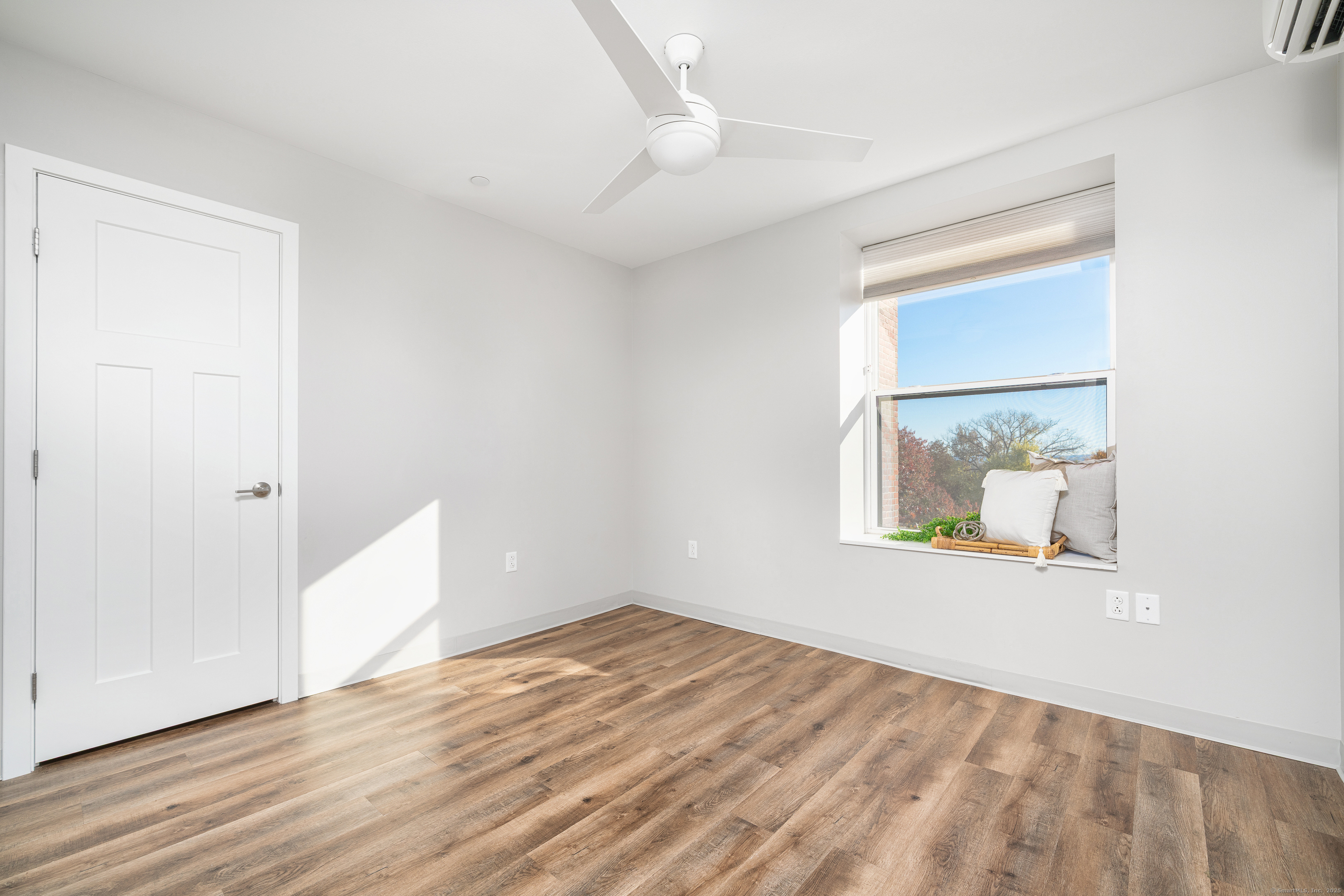 170 Ridge Road, Unit 304 Wethersfield, CT 06109 - Photo 17 of 25 an empty room with wooden floor and windows