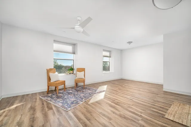 a view of a livingroom with wooden floor and a window