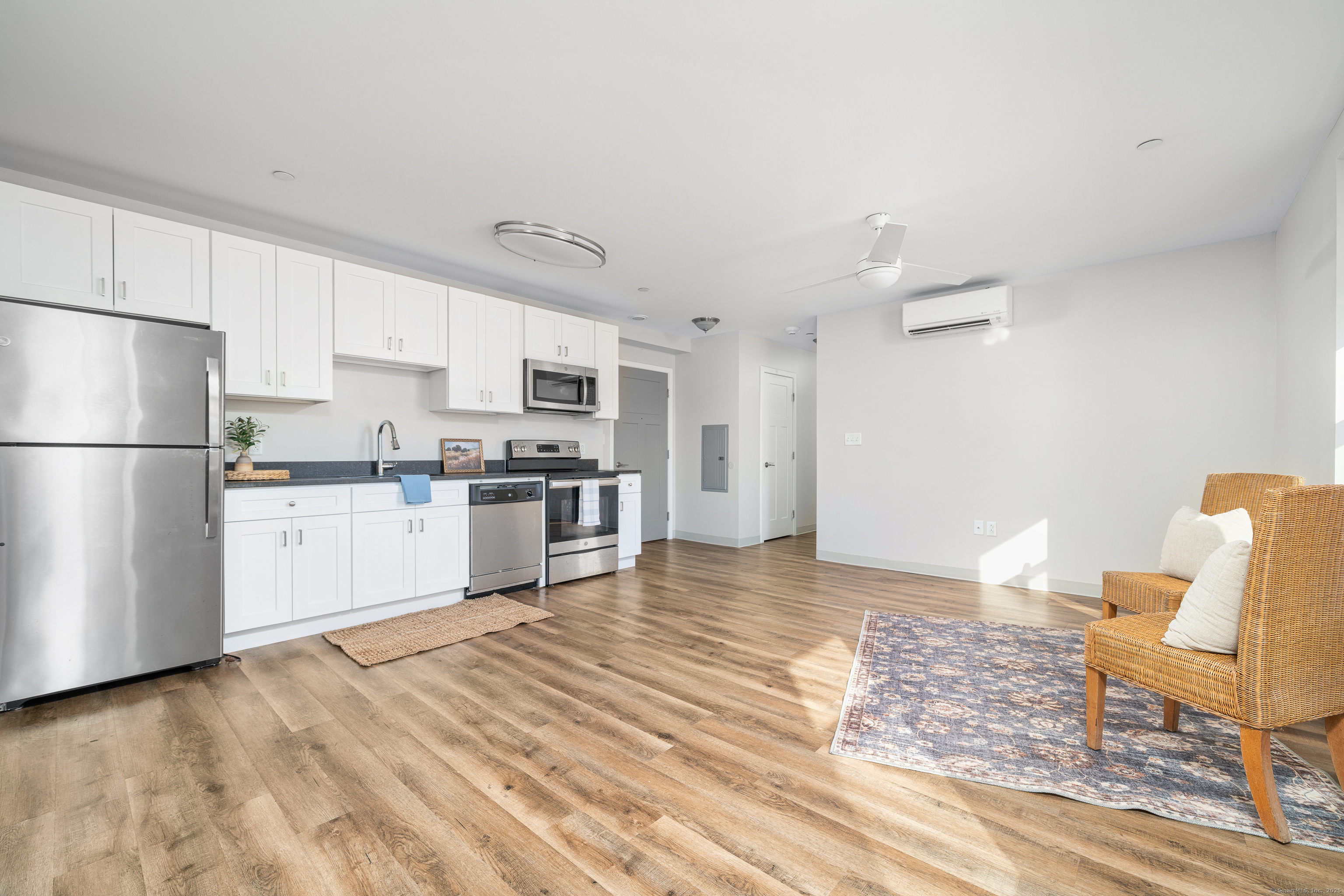 170 Ridge Road, Unit 304 Wethersfield, CT 06109 - Photo 5 of 25 a kitchen with stainless steel appliances granite countertop a refrigerator sink and white cabinets