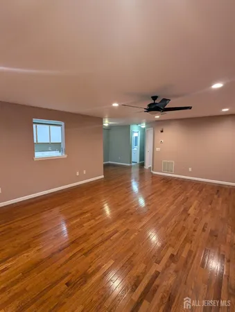 a view of an empty room and wooden floor
