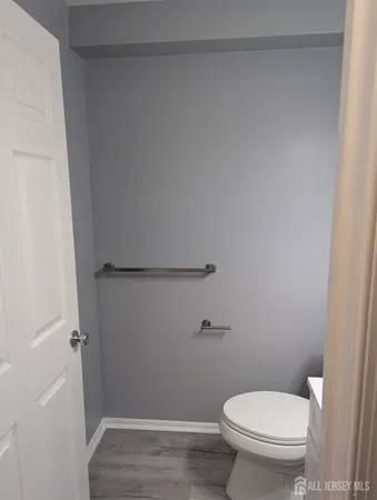 a bathroom with a toilet a sink and shower