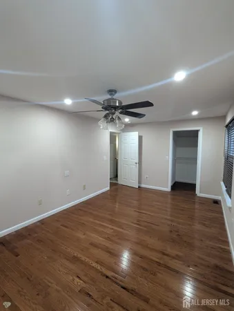 a view of an empty room and wooden floor