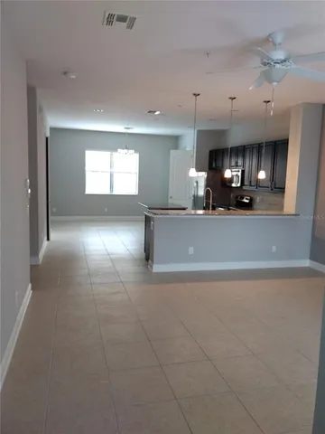 a view of a kitchen with a sink and a large window