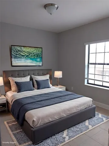 a bedroom with bed and window