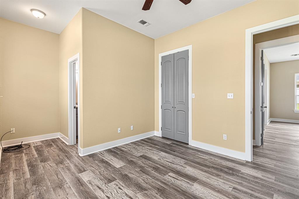 10160 Wallace Road Holland, TX 76534 - Photo 11 of 40 Unfurnished bedroom with wood finished floors, a closet, and ceiling fan