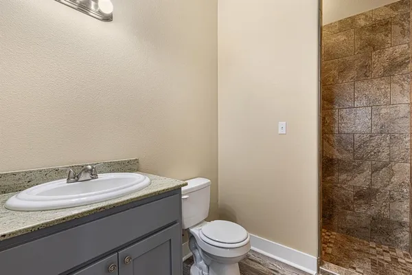 a bathroom with a sink toilet and a mirror