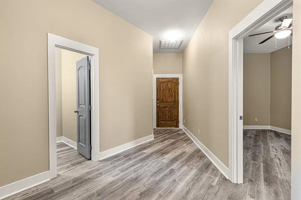 a view of hallway with wooden floor