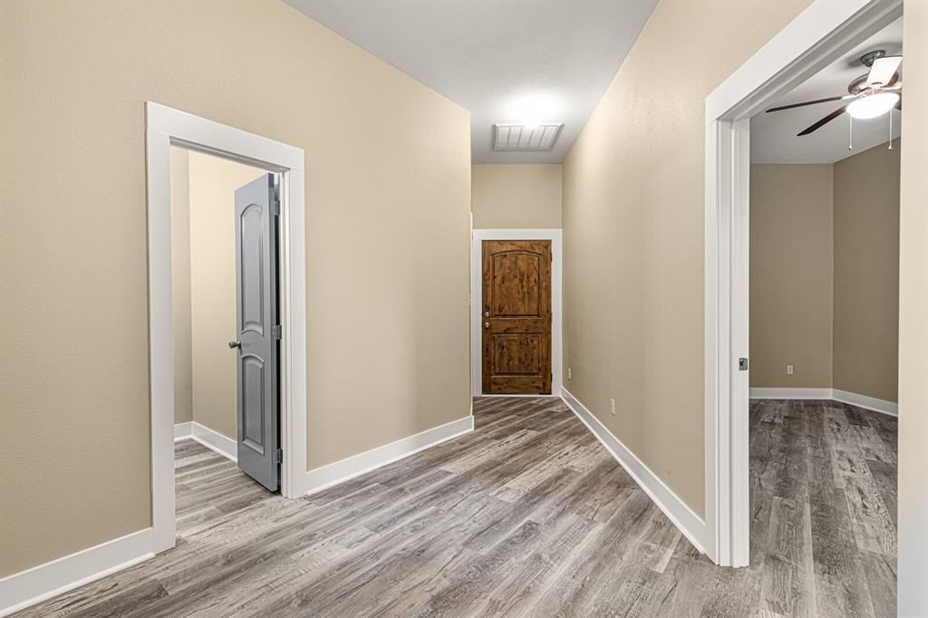 10160 Wallace Road Holland, TX 76534 - Photo 18 of 40 Hallway featuring light wood-style floors and baseboards
