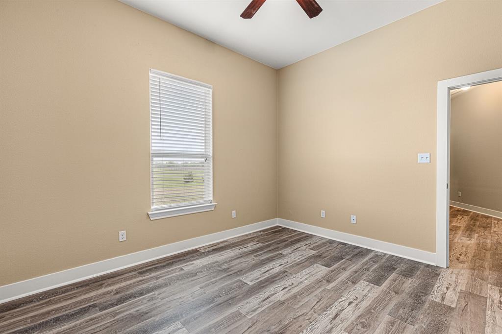 10160 Wallace Road Holland, TX 76534 - Photo 20 of 40 Spare room featuring wood finished floors and a ceiling fan