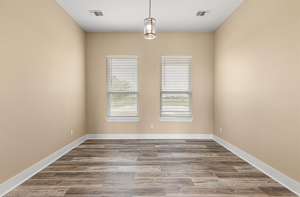 10160 Wallace Road Holland, TX 76534 - Photo 25 of 40 Spare room featuring wood finished floors and baseboards
