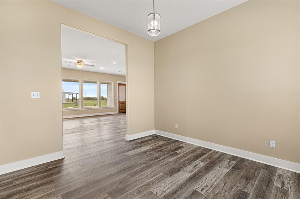 10160 Wallace Road Holland, TX 76534 - Photo 26 of 40 Unfurnished room featuring dark wood-type flooring and baseboards
