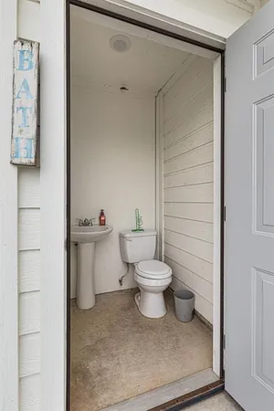 a white toilet sitting next to a bathroom sink