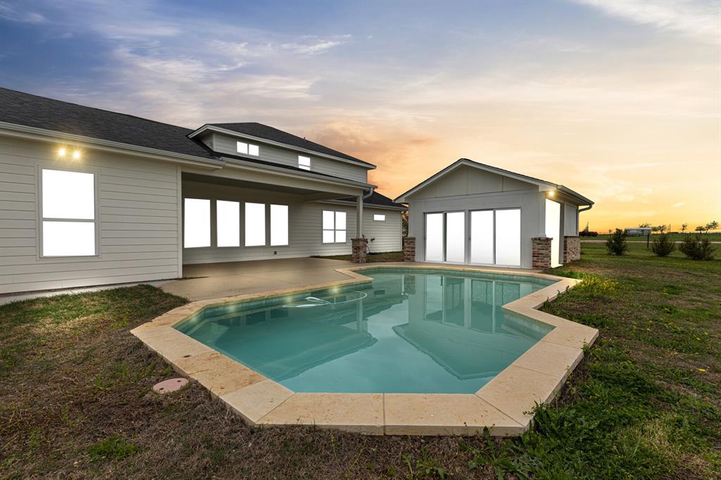 10160 Wallace Road Holland, TX 76534 - Photo 35 of 40 Back of property with a lawn, an outdoor pool, a patio area, and an outdoor structure