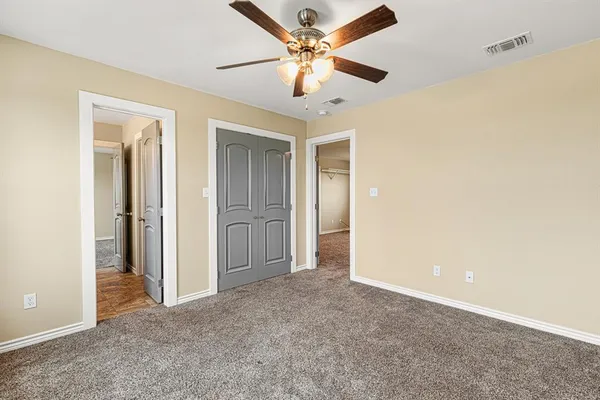 a view of a livingroom with a ceiling fan and a window