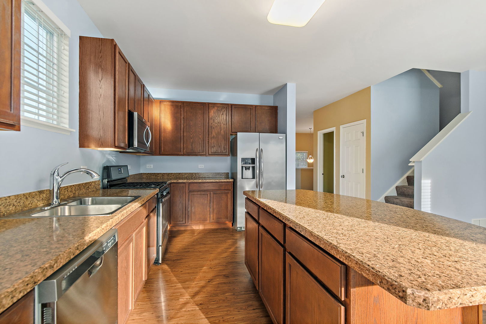 413 Town Center Boulevard Gilberts, IL 60136 - Photo 13 of 34 a kitchen with stainless steel appliances granite countertop wooden cabinets a sink and dishwasher