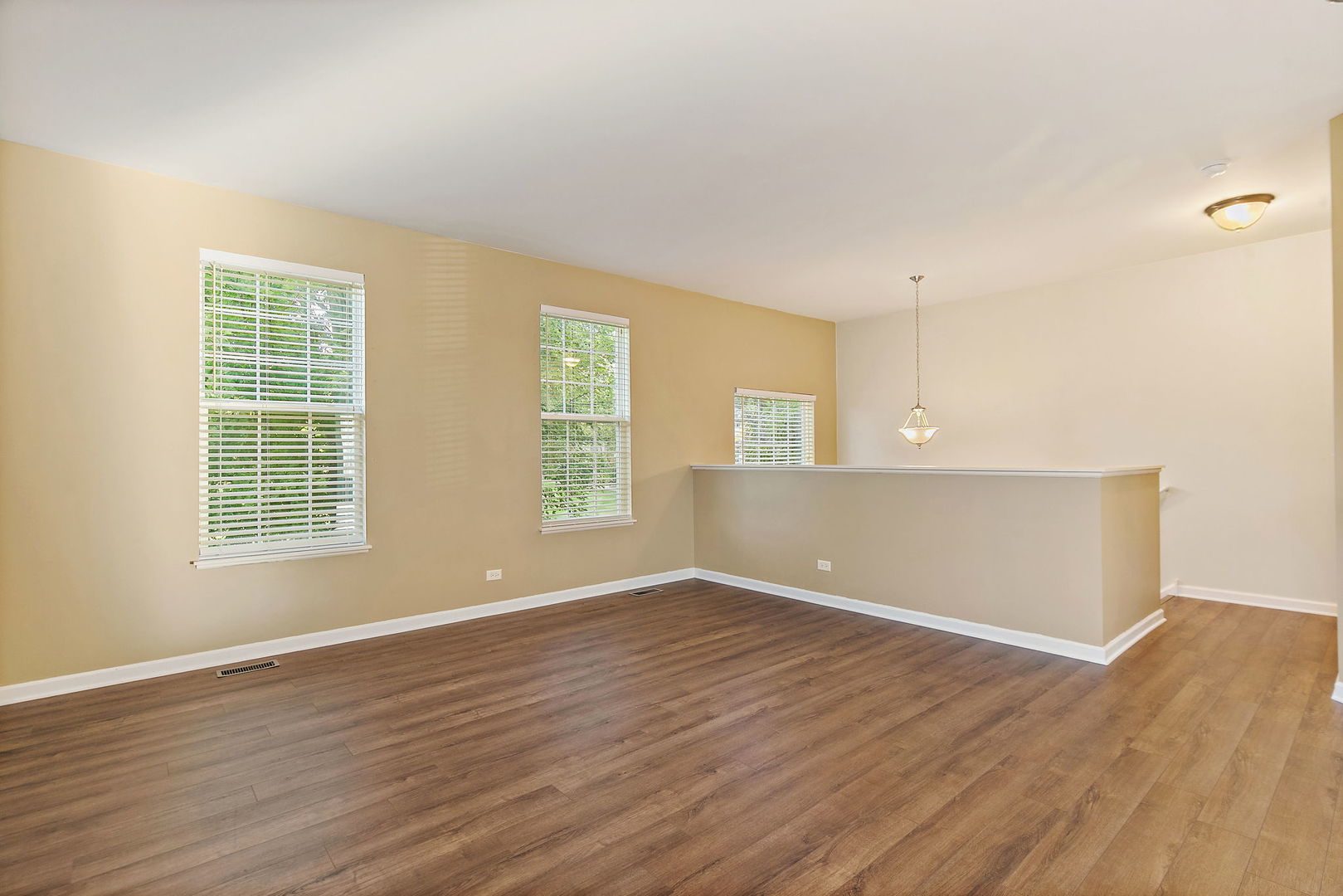 413 Town Center Boulevard Gilberts, IL 60136 - Photo 5 of 34 an empty room with wooden floor and windows
