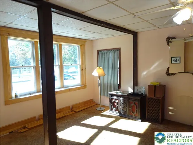 a view of a workspace with furniture and a window