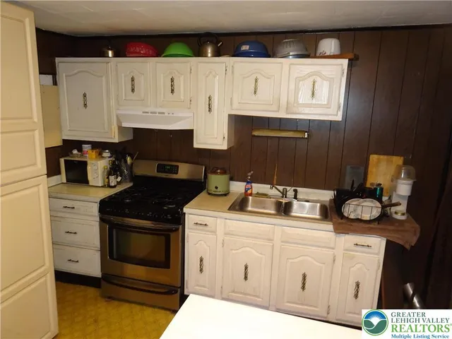 a kitchen with a stove and cabinets