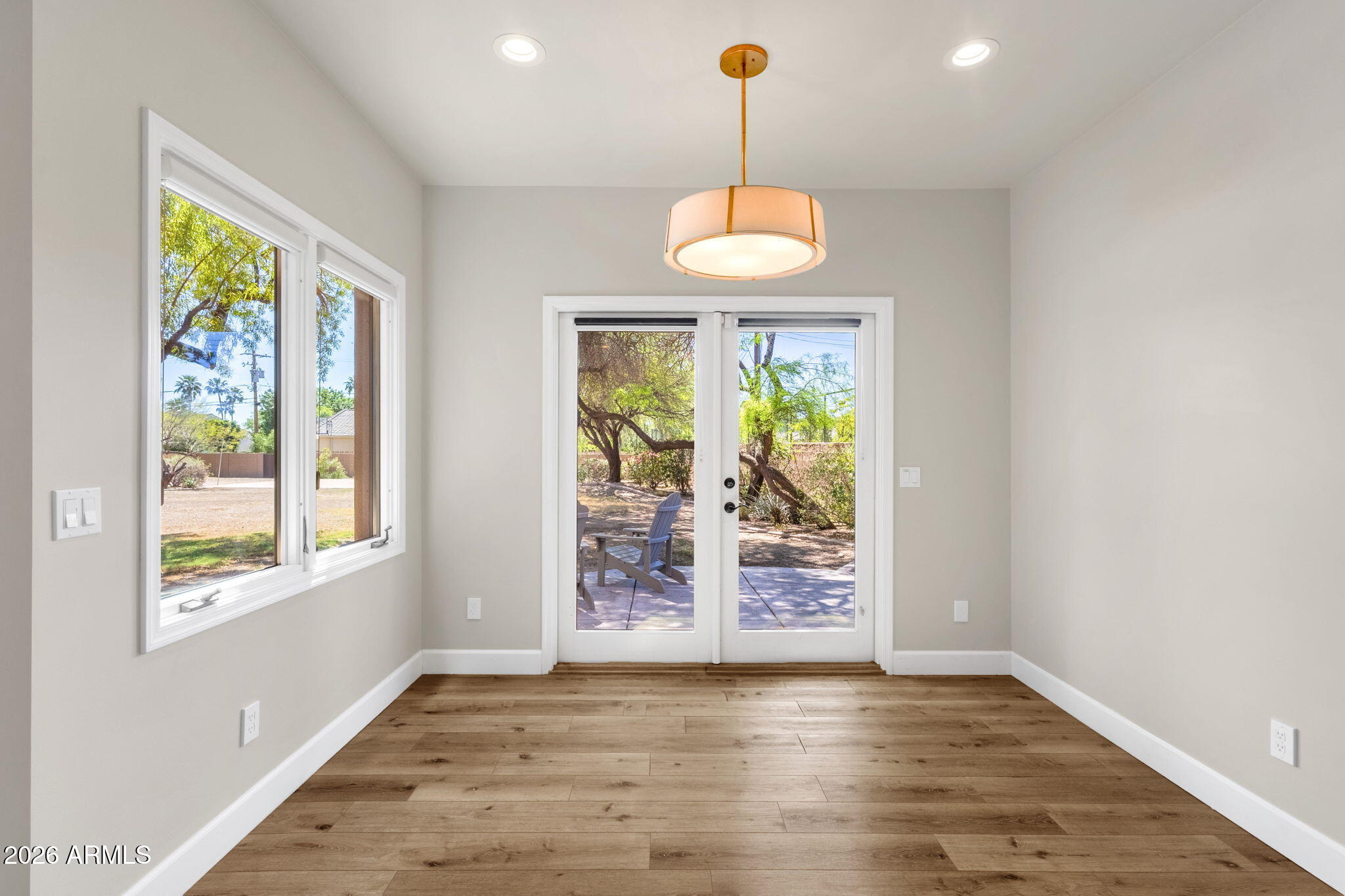 4139 East Colter Street Phoenix, AZ 85018 - Photo 24 of 58 a view of an empty room with window wooden floor and outside view