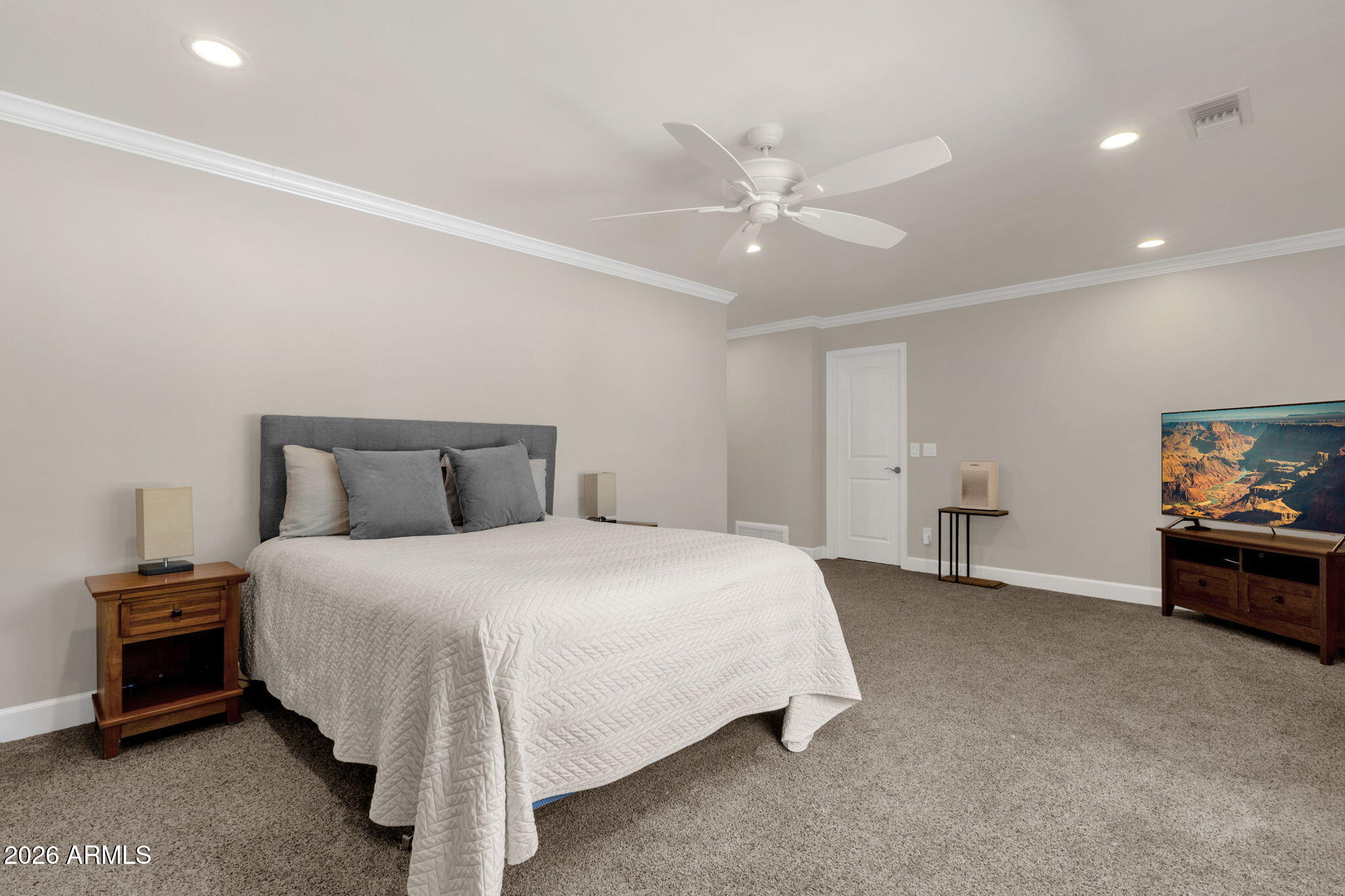 4139 East Colter Street Phoenix, AZ 85018 - Photo 29 of 58 a spacious bedroom with a bed and a chandelier