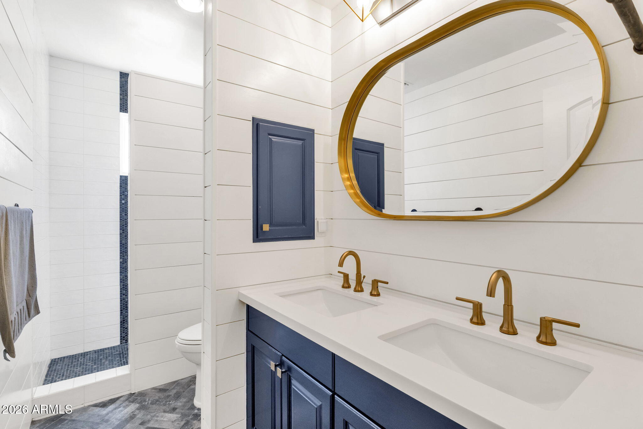 4139 East Colter Street Phoenix, AZ 85018 - Photo 31 of 58 a bathroom with a sink and a mirror