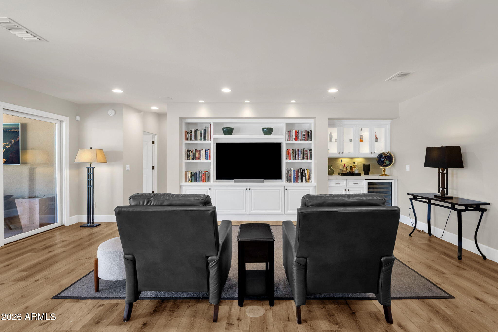 4139 East Colter Street Phoenix, AZ 85018 - Photo 33 of 58 a living room with furniture a flat screen tv and a refrigerator