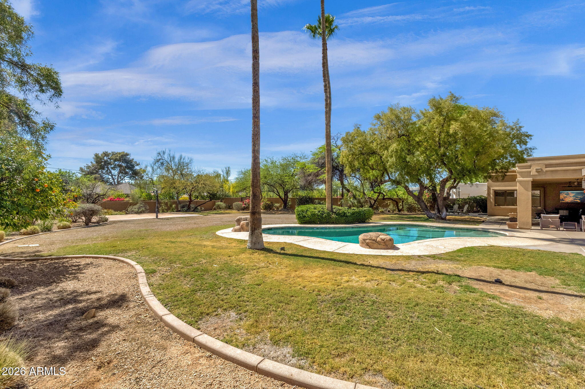 4139 East Colter Street Phoenix, AZ 85018 - Photo 56 of 58 a view of a swimming pool with a yard