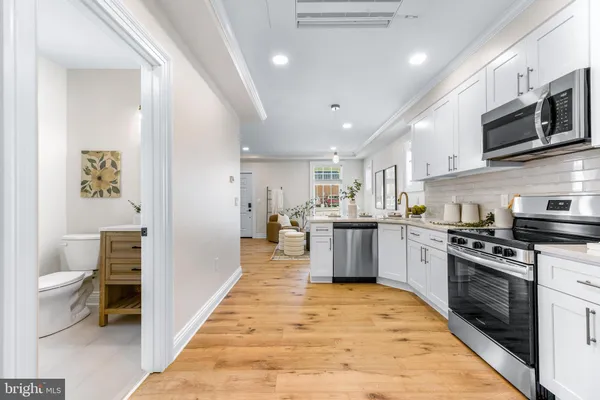 a kitchen with stainless steel appliances granite countertop lots of counter top space and cabinets