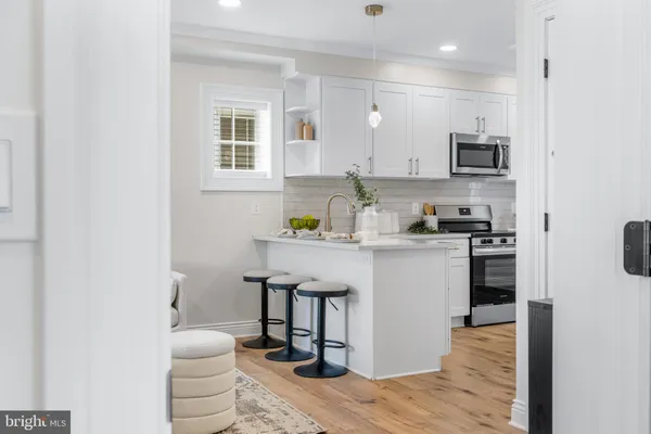 a kitchen with a sink appliances and cabinets
