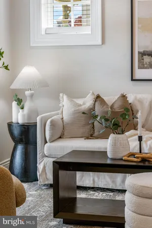 a living room with furniture and wall painting