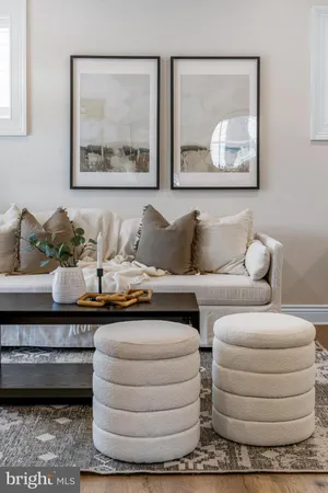 a living room with furniture and painting on the wall