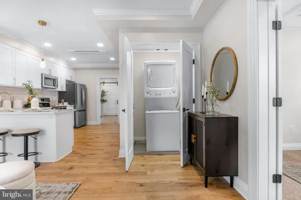 a view of kitchen with stainless steel appliances granite countertop refrigerator and a sink