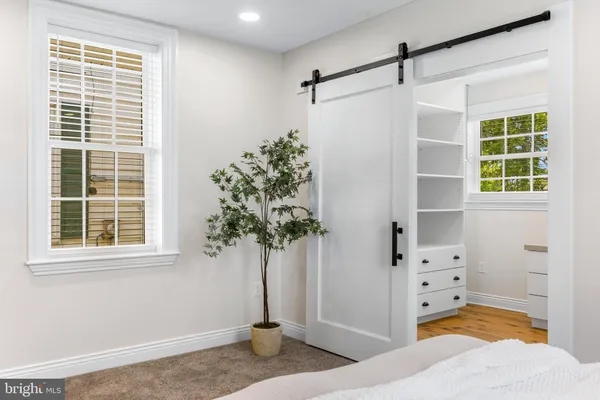a view of empty room with window and cabinet