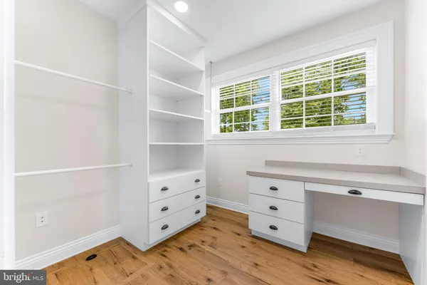 a room with white cabinets and a window