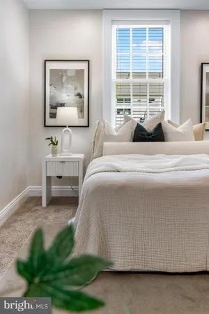 a spacious bedroom with a bed and a window