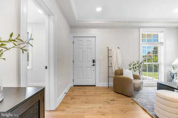 a living room with furniture rug and wooden floor