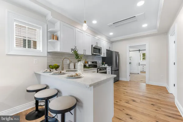 a kitchen with sink cabinets and dining table