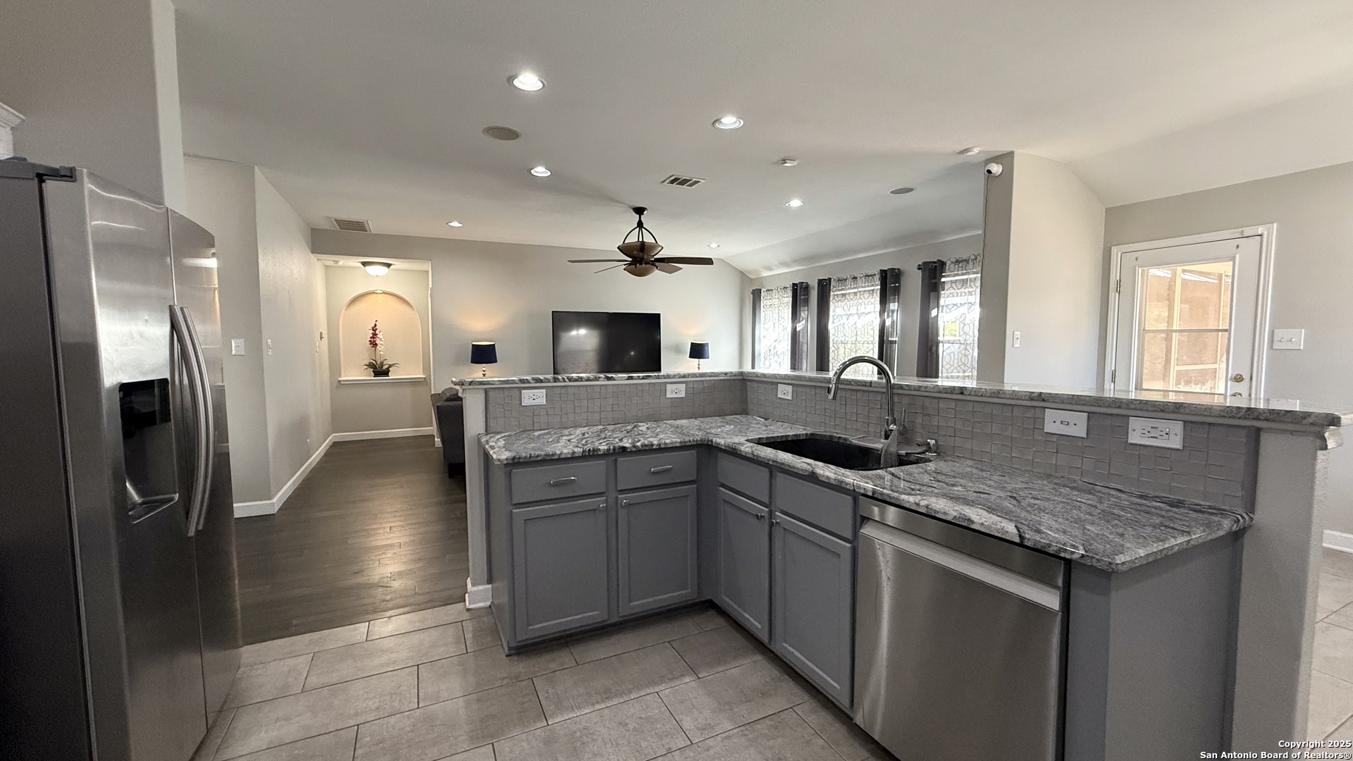 9402 Anderson Way Converse, TX 78109 - Photo 11 of 37 a kitchen with stainless steel appliances granite countertop a sink and a refrigerator