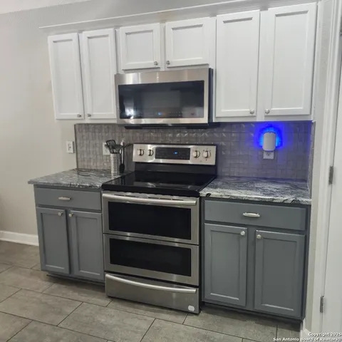 a view of a dining room with a table and chairs