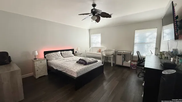 a room with a flat screen tv and furniture