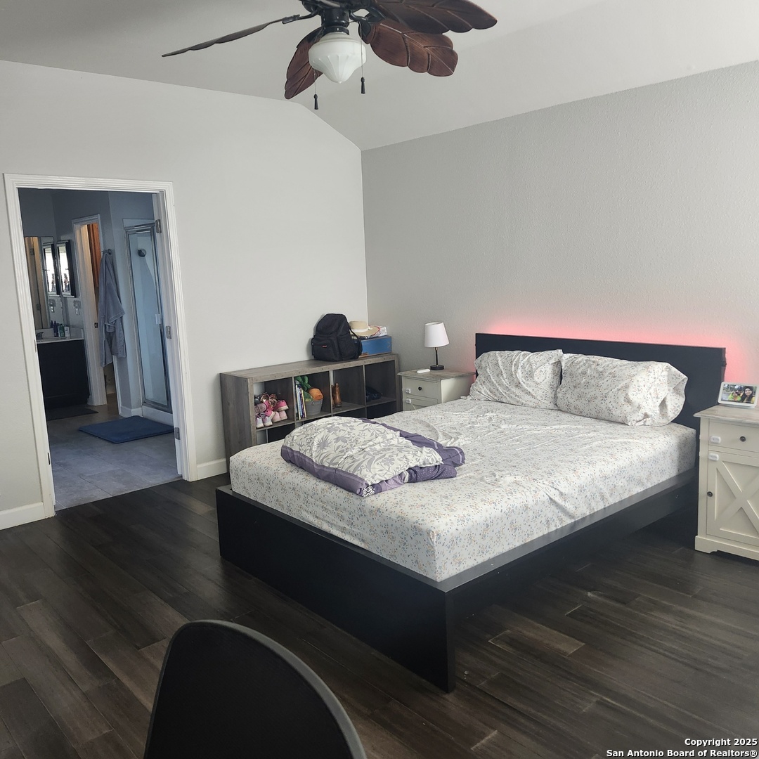 9402 Anderson Way Converse, TX 78109 - Photo 22 of 37 a bedroom with a bed and wooden floor